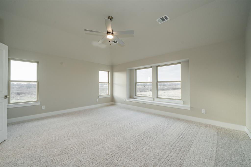 424 Deer Lane Celeste, TX 75423 - Photo 23 of 40 an empty room with chandelier fan and windows