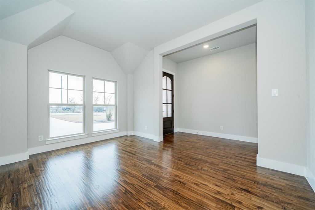 424 Deer Lane Celeste, TX 75423 - Photo 7 of 40 an empty room with wooden floor and windows
