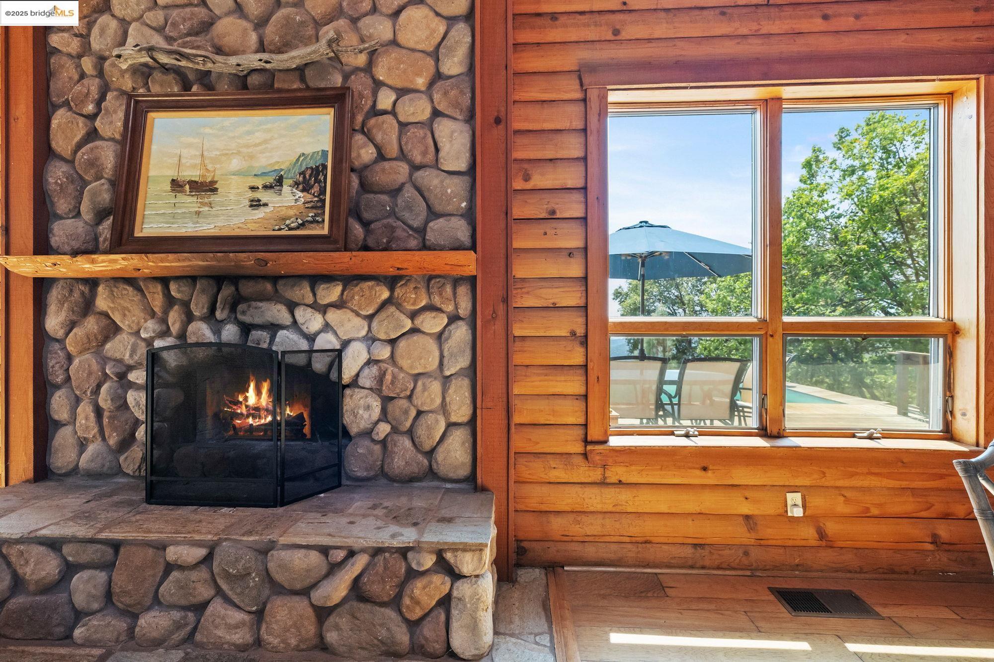 14799 Big Hill Road Sonora, CA 95370 - Photo 11 of 60 Detailed view of a fireplace and wood finished floors