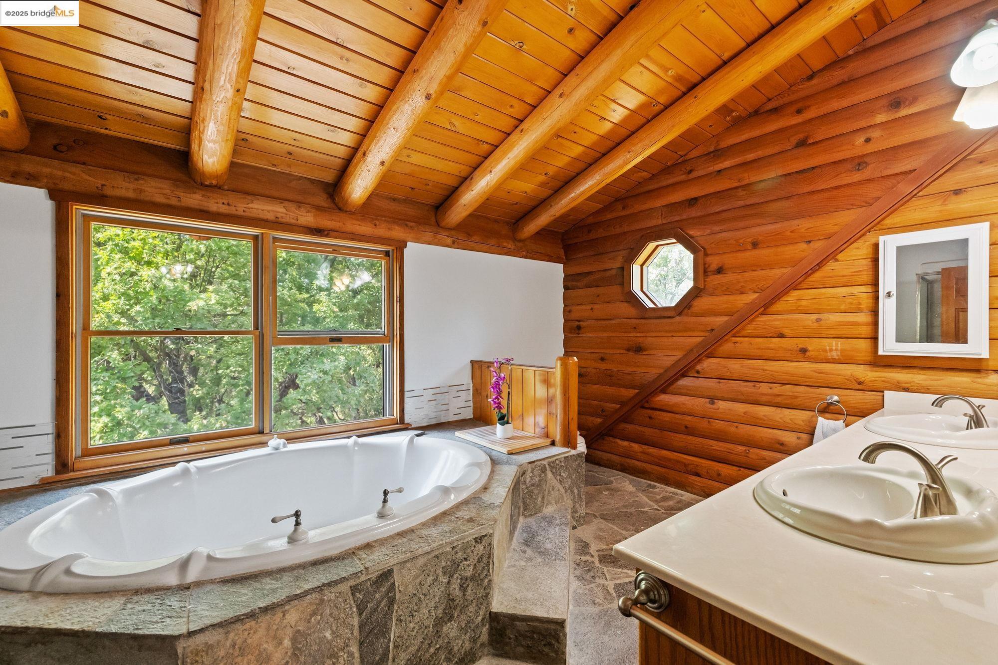 14799 Big Hill Road Sonora, CA 95370 - Photo 30 of 60 Bathroom with a bath, double vanity, wood ceiling, and stone finish flooring