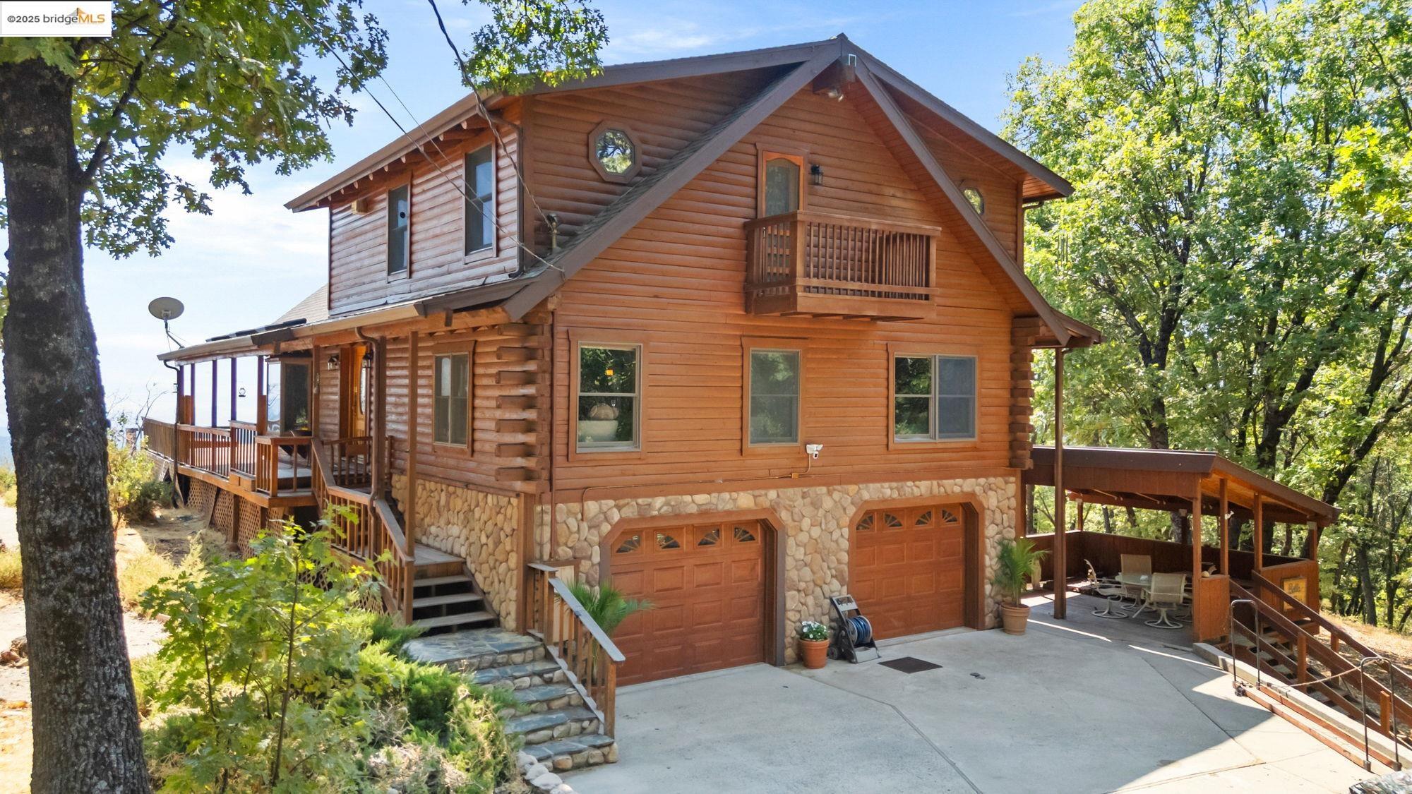 14799 Big Hill Road Sonora, CA 95370 - Photo 3 of 60 Cabin featuring log siding, stairway, a deck, driveway, and stone siding