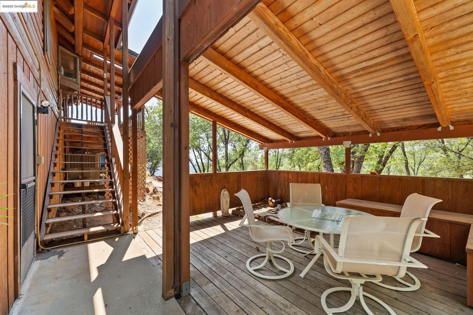 14799 Big Hill Road Sonora, CA 95370 - Photo 33 of 60 Wooden terrace with outdoor dining space and stairway