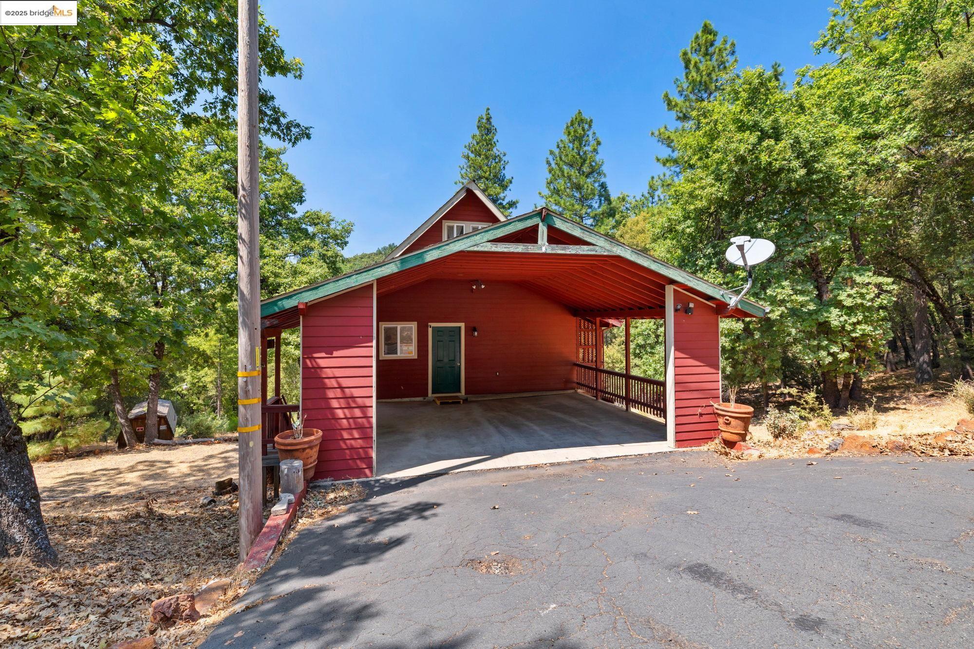 14799 Big Hill Road Sonora, CA 95370 - Photo 35 of 60 Garage with a carport and asphalt driveway