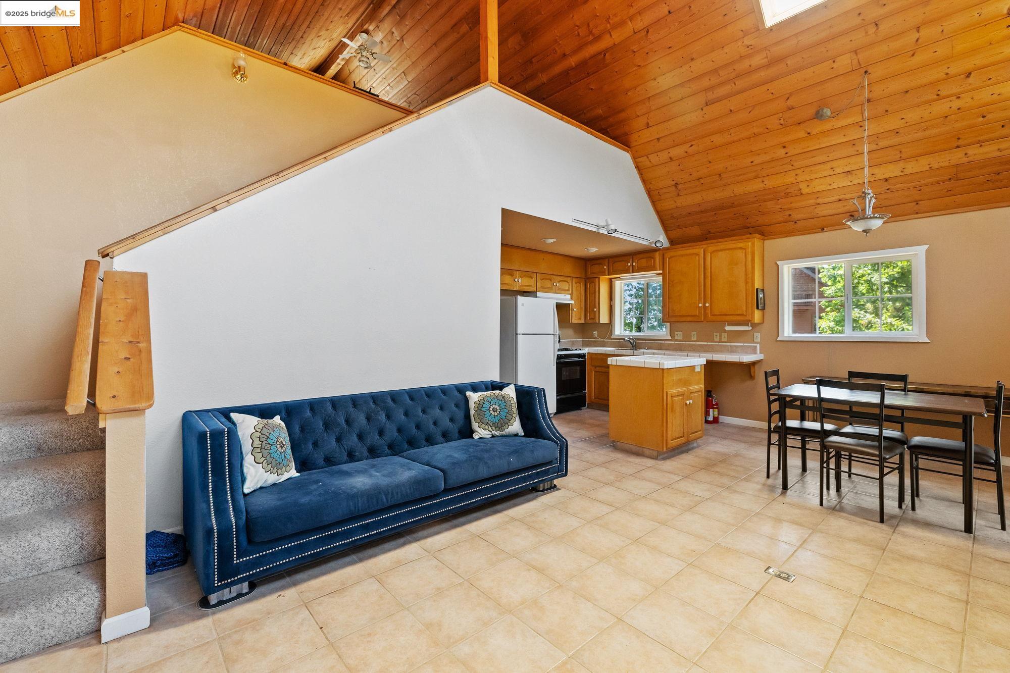 14799 Big Hill Road Sonora, CA 95370 - Photo 46 of 60 Living area with wood ceiling, stairs, and high vaulted ceiling