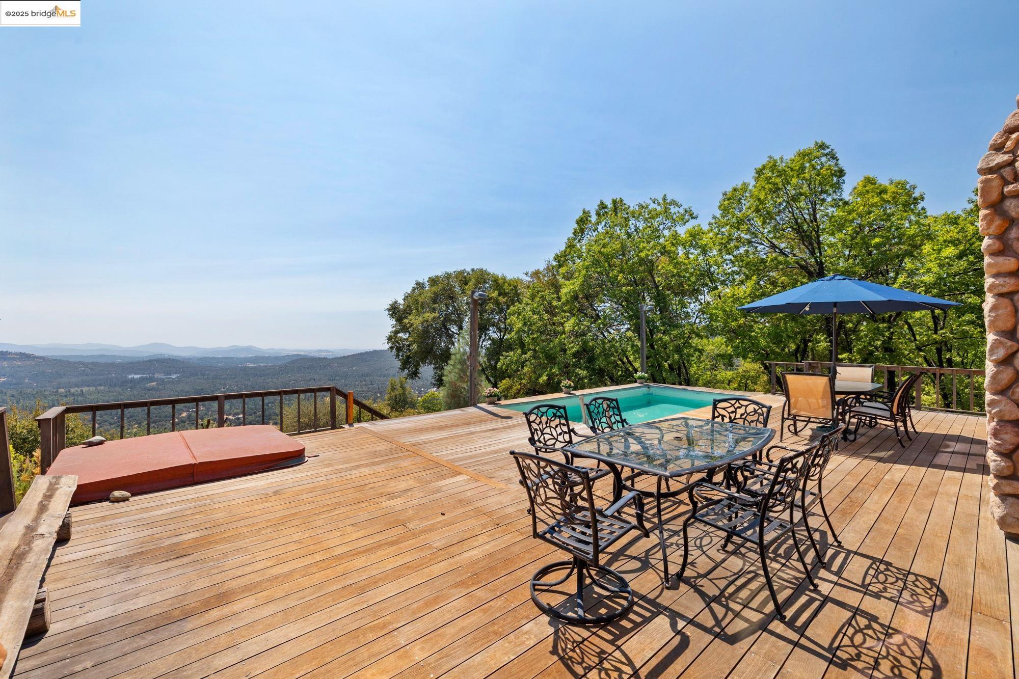14799 Big Hill Road Sonora, CA 95370 - Photo 52 of 60 Wooden deck with outdoor dining space and a mountain view