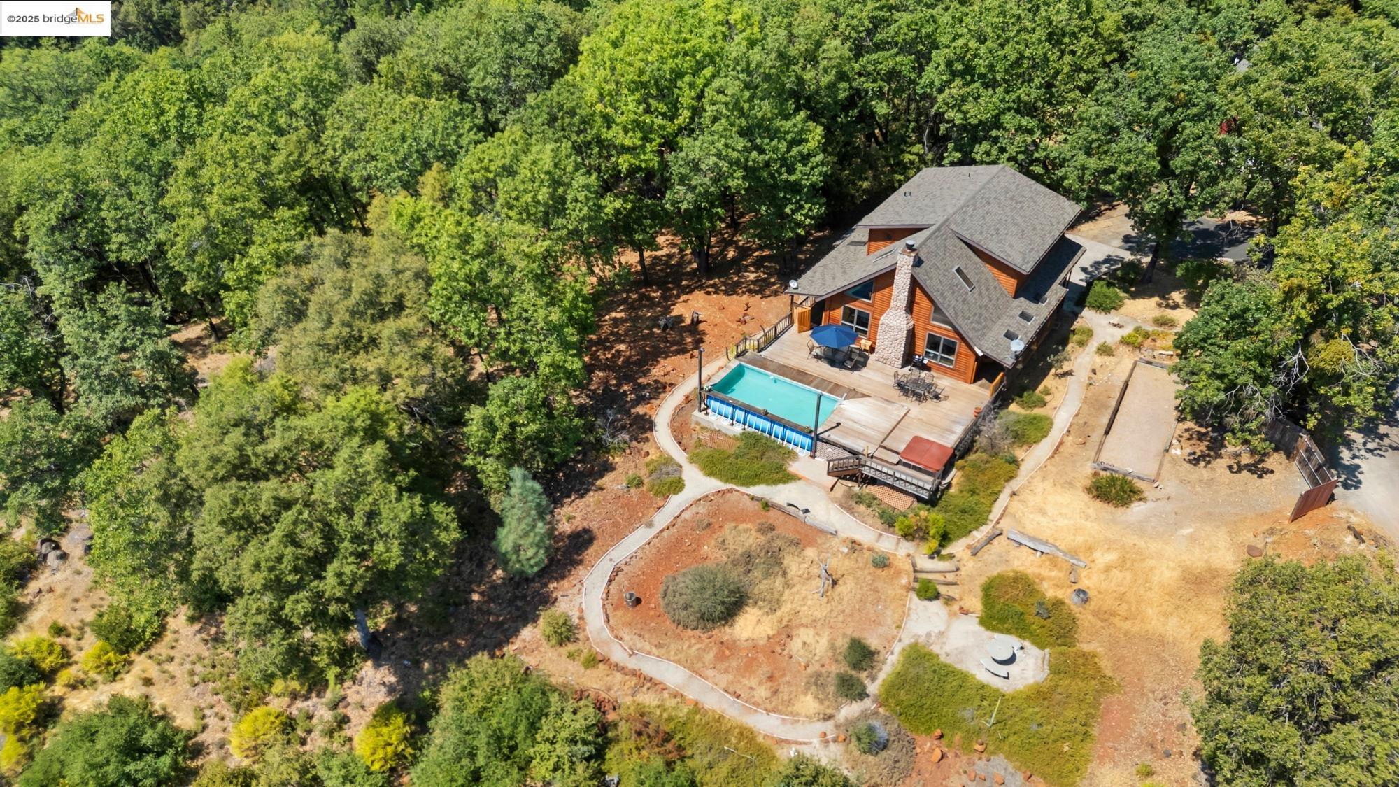 14799 Big Hill Road Sonora, CA 95370 - Photo 58 of 60 View from above of property featuring a heavily wooded area and a pool