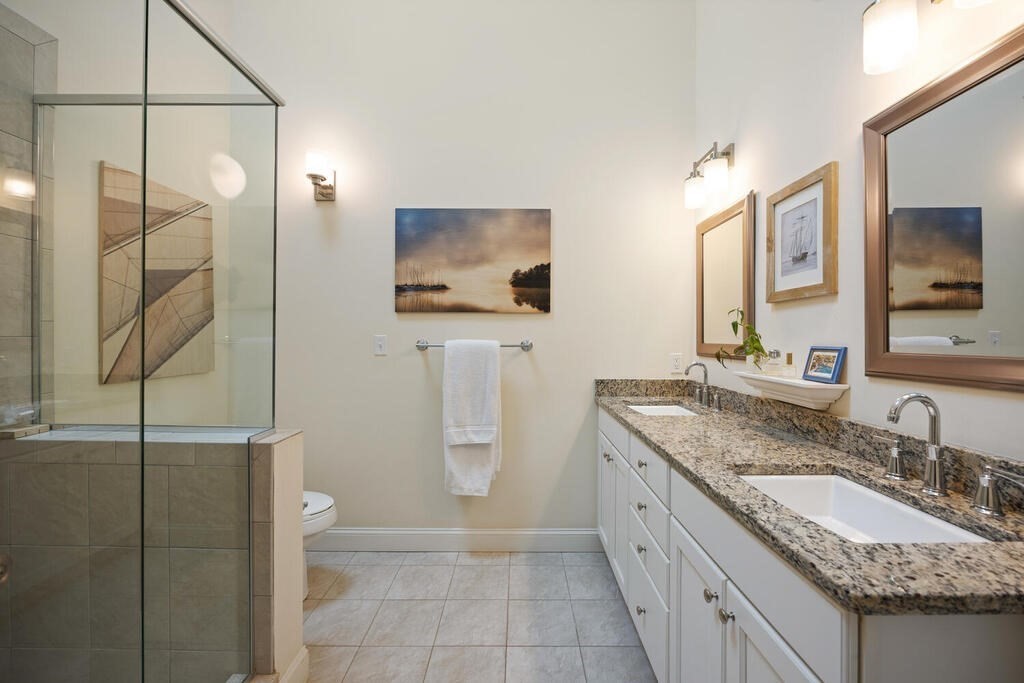 23 Courtyard Place, Unit 23 Lexington, MA 02420 - Photo 16 of 28 a spacious bathroom with a granite countertop sink a mirror and a toilet