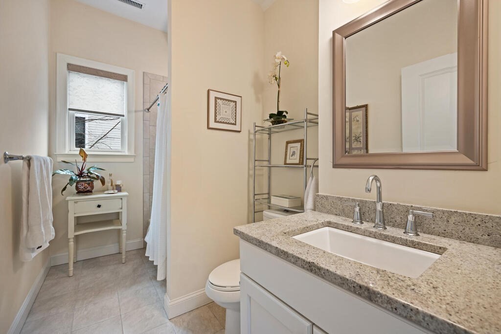 23 Courtyard Place, Unit 23 Lexington, MA 02420 - Photo 19 of 28 a bathroom with a granite countertop sink a toilet and a mirror