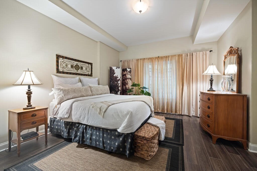 23 Courtyard Place, Unit 23 Lexington, MA 02420 - Photo 21 of 28 a bedroom with a bed a dresser and wooden floor