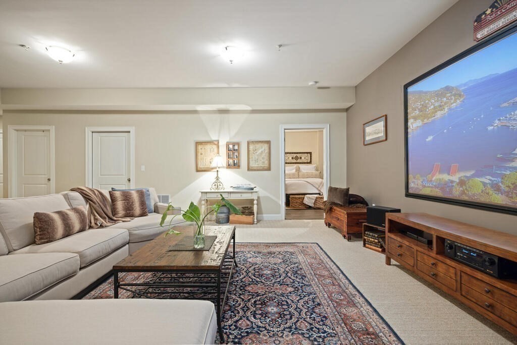 23 Courtyard Place, Unit 23 Lexington, MA 02420 - Photo 23 of 28 a living room with furniture and a flat screen tv