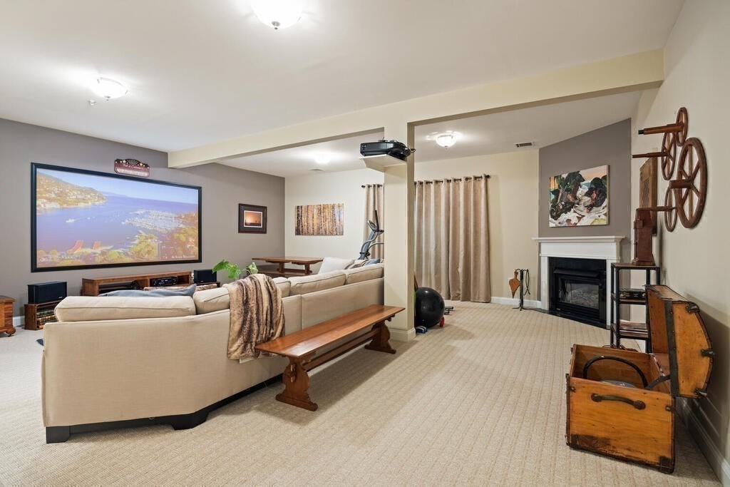 23 Courtyard Place, Unit 23 Lexington, MA 02420 - Photo 24 of 28 a living room with furniture and a flat screen tv