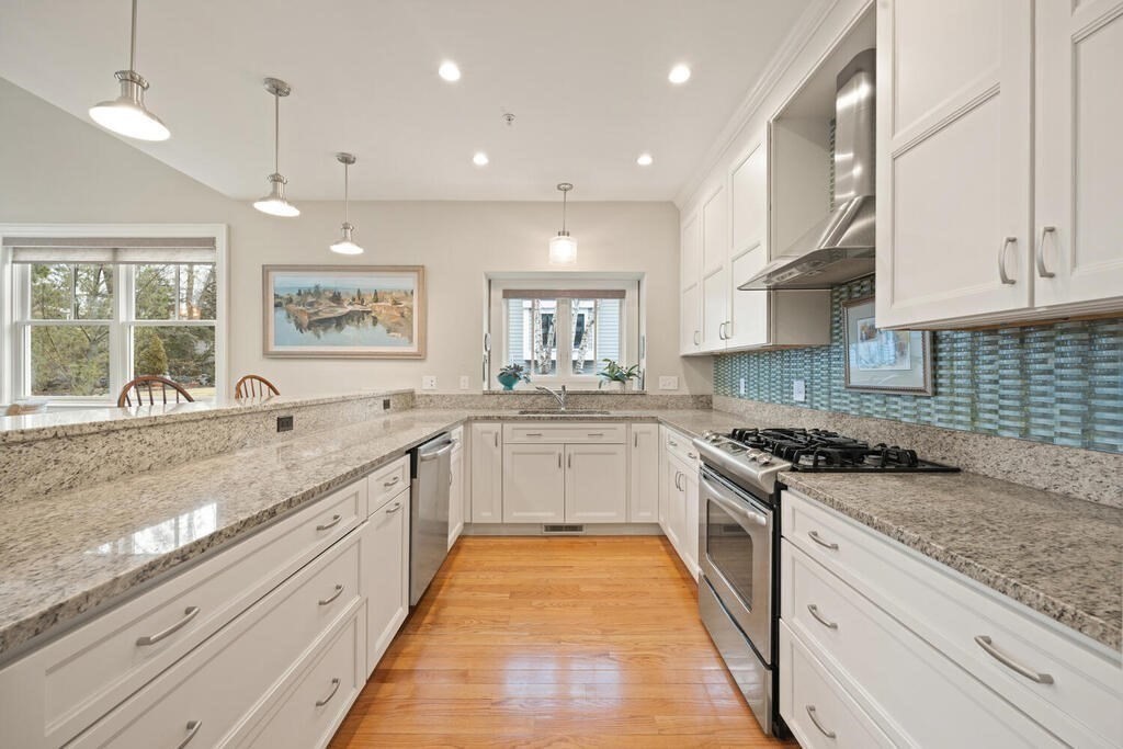 23 Courtyard Place, Unit 23 Lexington, MA 02420 - Photo 9 of 28 a large kitchen with stainless steel appliances granite countertop a stove and a sink