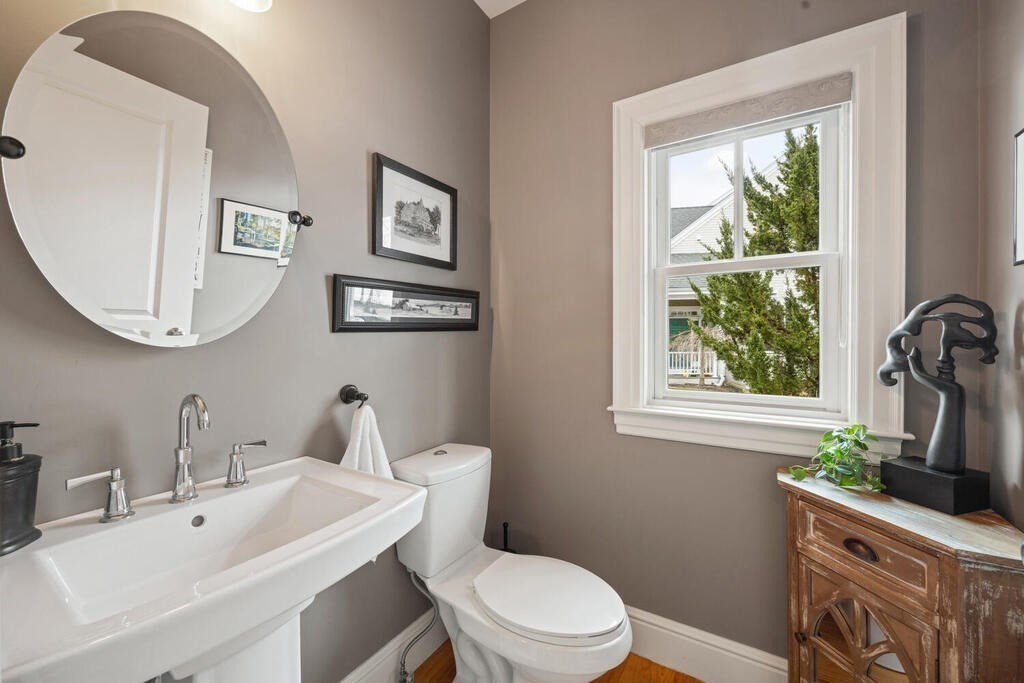 23 Courtyard Place, Unit 23 Lexington, MA 02420 - Photo 10 of 28 a bathroom with a toilet a sink a mirror and a window
