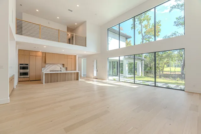 a view of an empty room with a fireplace and a large window