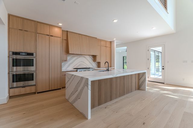 a view of a kitchen with a sink and a refrigerator