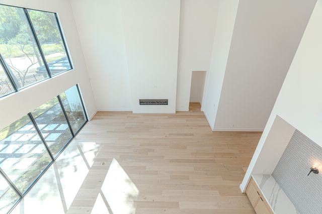 a view of a room with wooden floor and windows