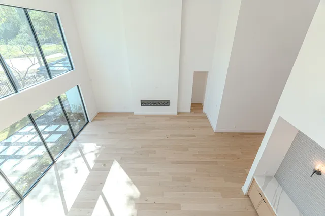 a view of a room with wooden floor and windows