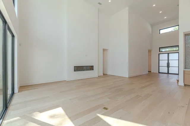 a view of a kitchen with refrigerator and wooden floor