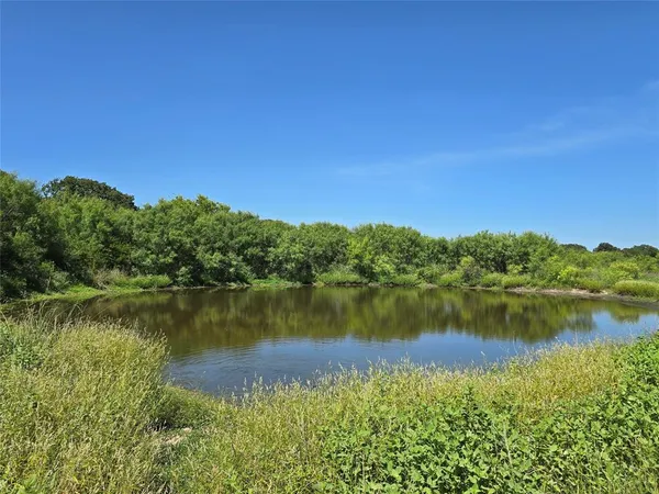 a view of a lake with houses in the back
