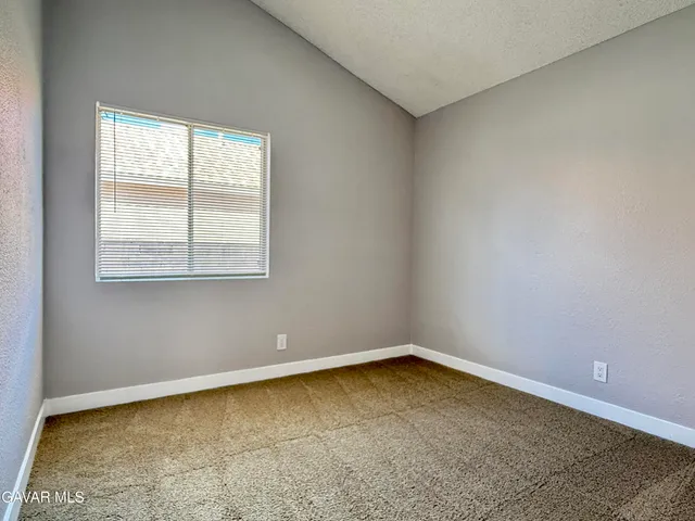 an empty room with closet and a bathroom