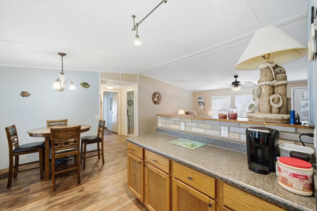 6715 West Richard Drive Weeki Wachee, FL 34607 - Photo 11 of 47 a large kitchen with a table and chairs in it