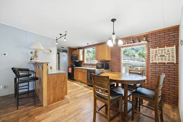 a view of a dining room with furniture window and wooden floor