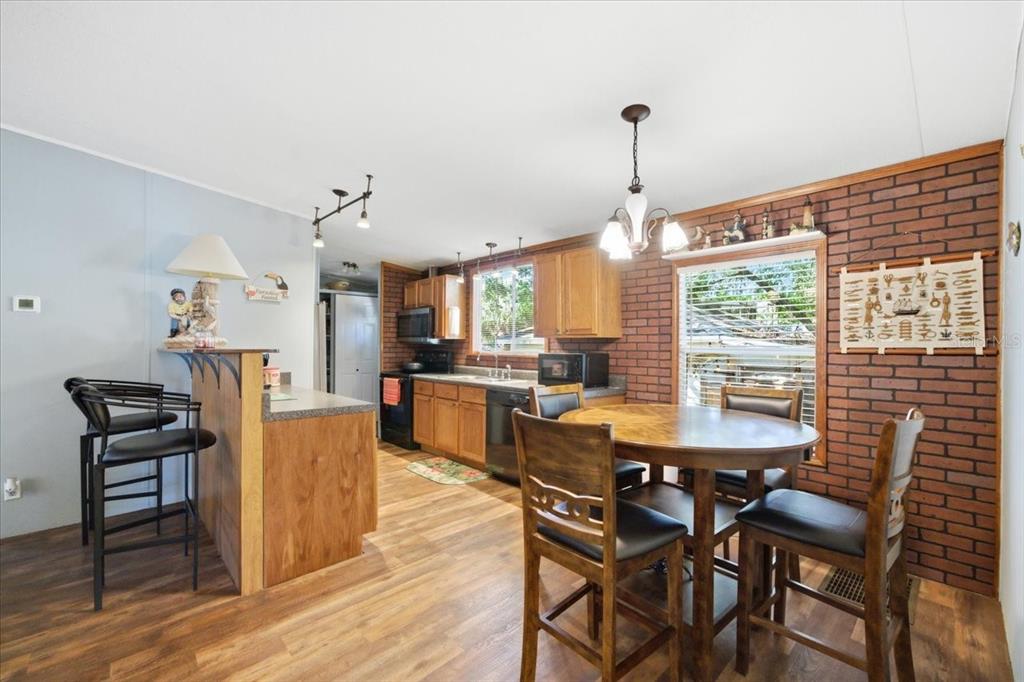 6715 West Richard Drive Weeki Wachee, FL 34607 - Photo 12 of 47 a view of a dining room with furniture window and wooden floor