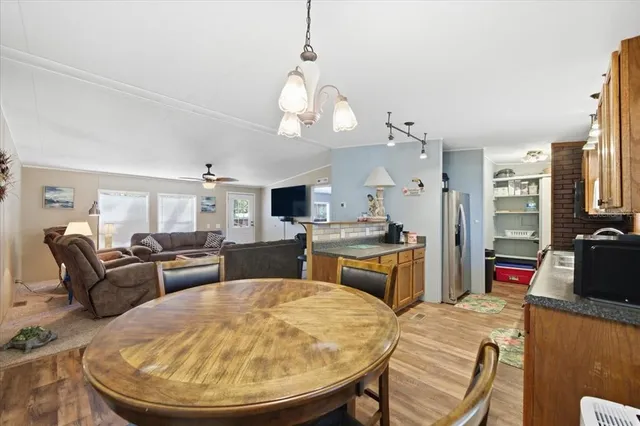 a living room with furniture a flat screen tv and kitchen view