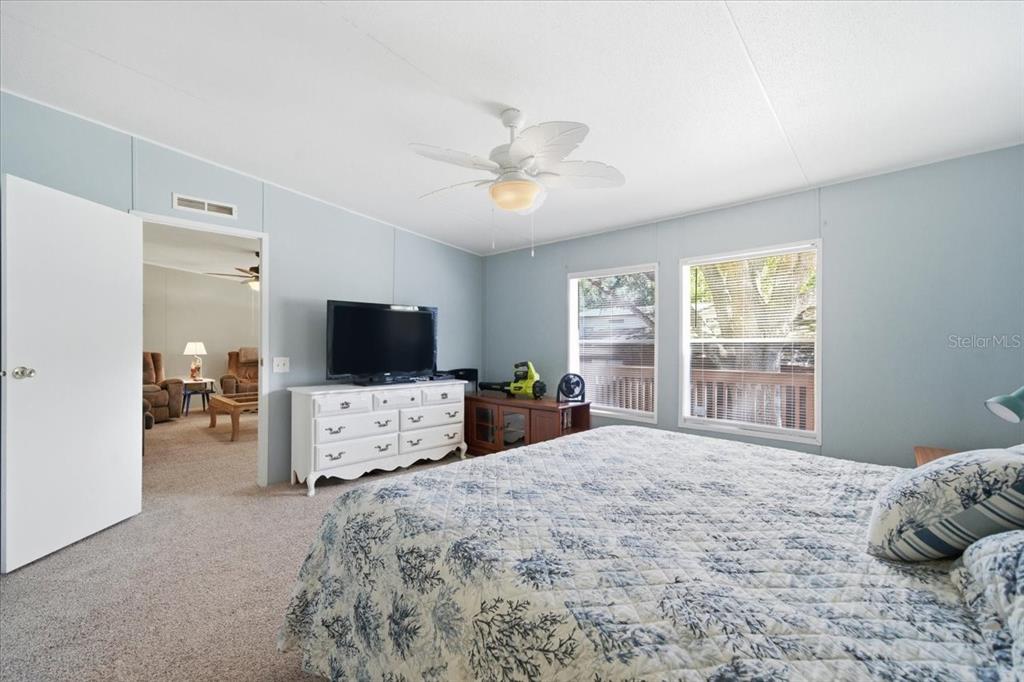 6715 West Richard Drive Weeki Wachee, FL 34607 - Photo 17 of 47 a bedroom with a bed and a flat screen tv