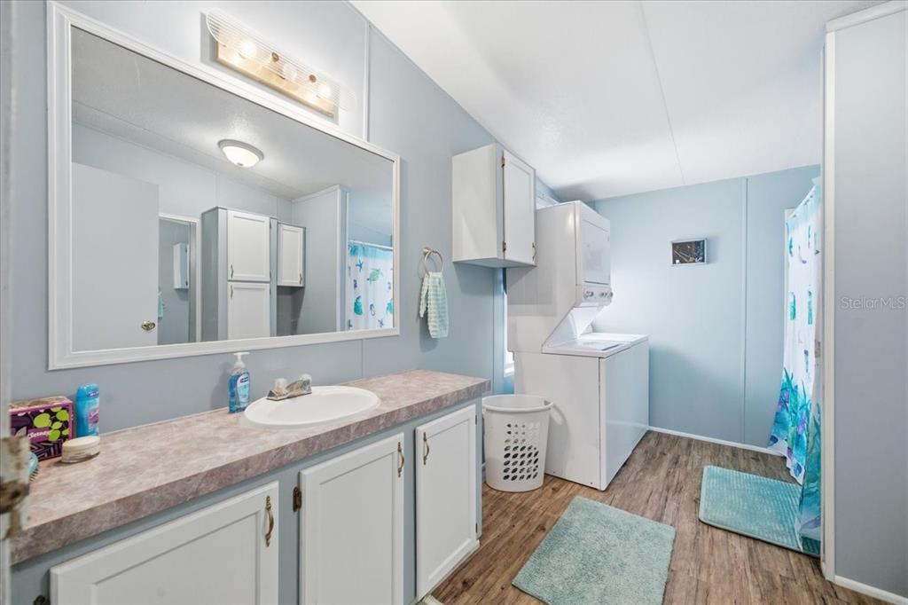 6715 West Richard Drive Weeki Wachee, FL 34607 - Photo 18 of 47 a bathroom with a sink and a mirror