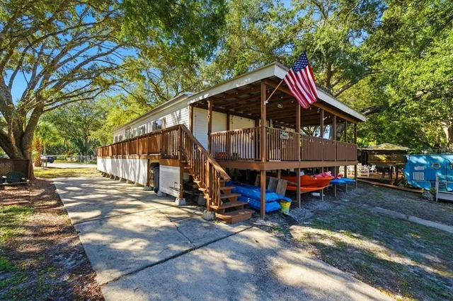 a view of a house with a yard patio and deck