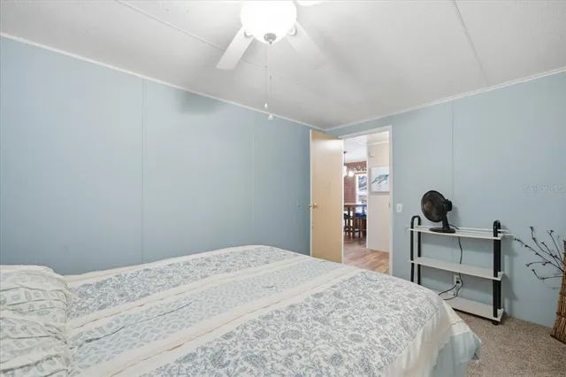 a bedroom with a bed and a desk in it