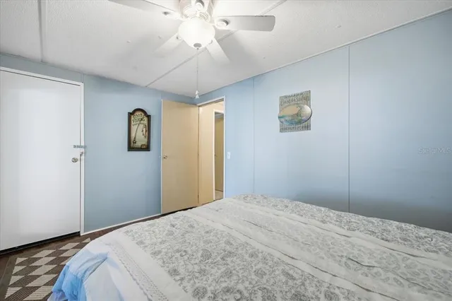 a bedroom with a large bed and a chandelier