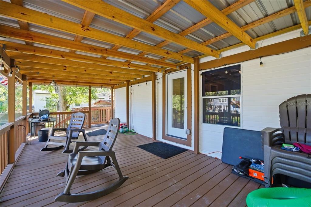 6715 West Richard Drive Weeki Wachee, FL 34607 - Photo 27 of 47 a view of a deck with wooden floor and outdoor seating