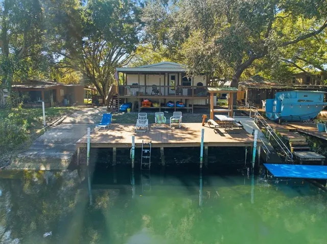 a view of a house with backyard porch and sitting area