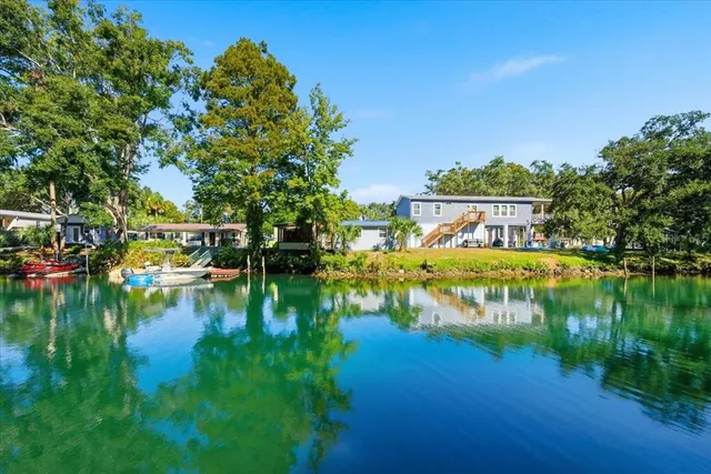 a view of residential house with outdoor space and lake view