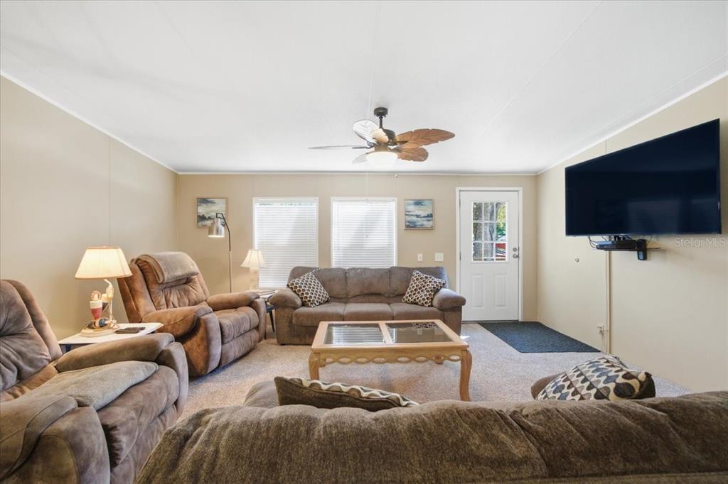 6715 West Richard Drive Weeki Wachee, FL 34607 - Photo 5 of 47 a living room with furniture and a flat screen tv