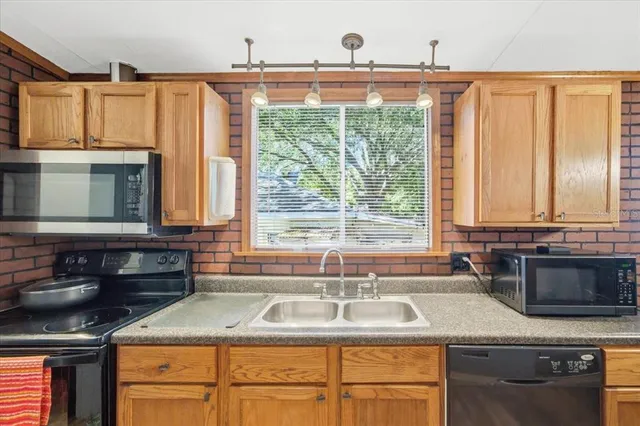 a kitchen with granite countertop a sink and a window