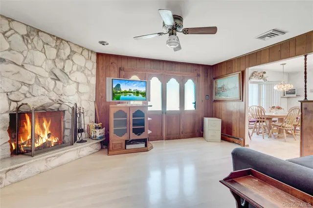 a living room with furniture gym equipment and a fireplace
