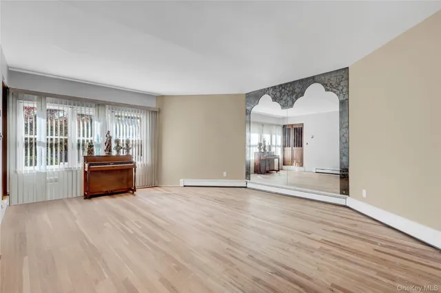 a living room with a couch and a wooden floor