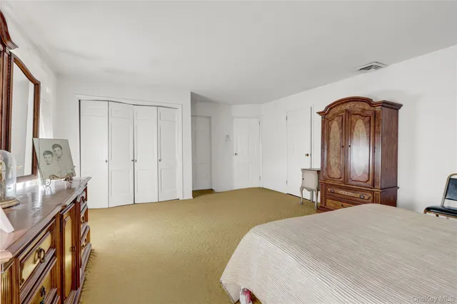 a bedroom with a bed and a dresser