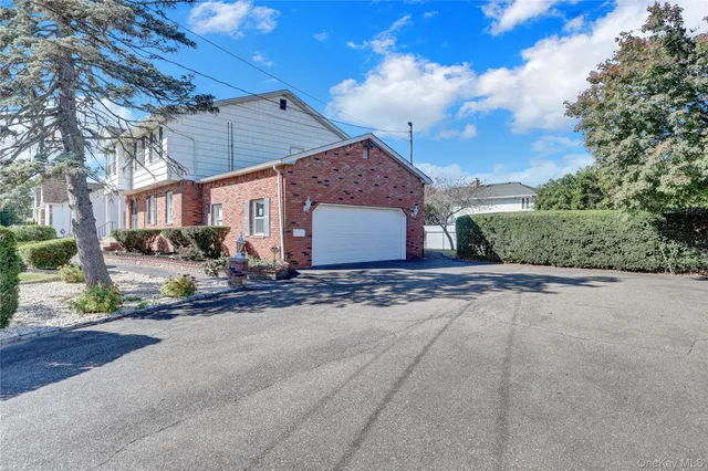 a view of a house with a yard and garage