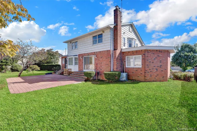 a front view of house with a garden
