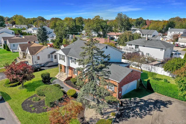 an aerial view of a house with a garden and lake view