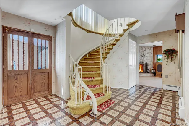 a view of entryway and hall with wooden floor