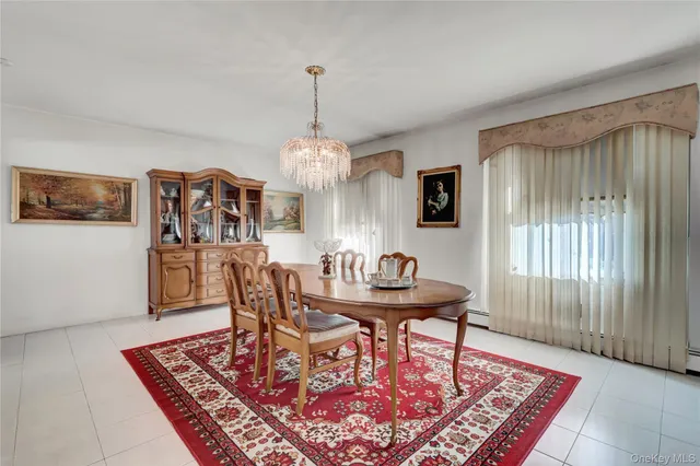 a dining room with furniture a rug a rug and a chandelier