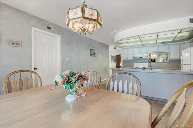 a bedroom with a bed table and chairs