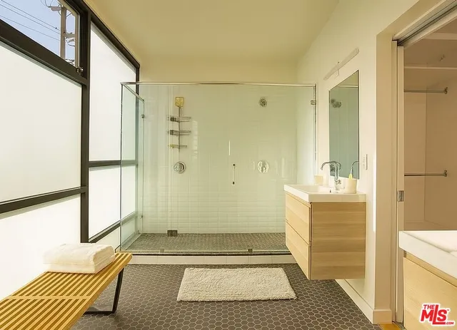 a blue couch sitting in a room next to a cabinet