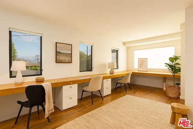 a living room with furniture a rug and a table