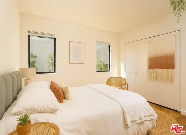 a bedroom with a bed and wooden floor